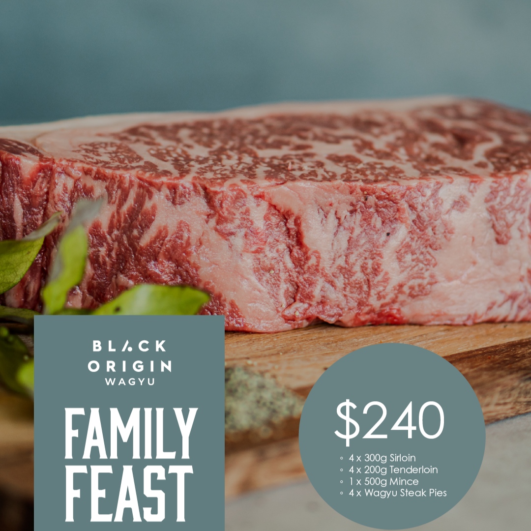Raw sirloin steak on a wooden board with 'Black Origin Wagyu' branding and pricing information.