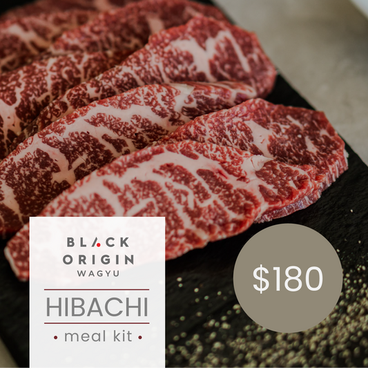 Marbled raw beef on a black surface with 'Black Origin Wagyu' branding and price displayed.