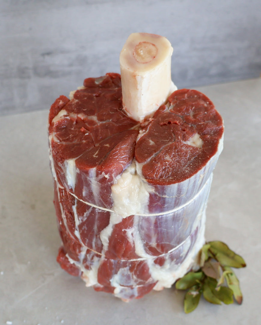 Raw beef Shank on a white surface with a blurred background