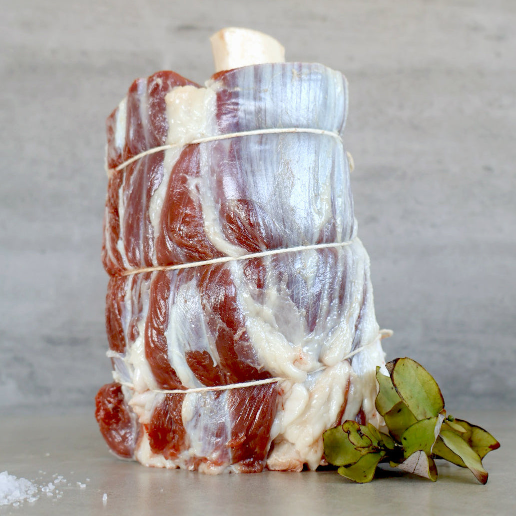 bone - in Wagyu Shank aka Thors Hammer with sprig of horopito on a grey surface