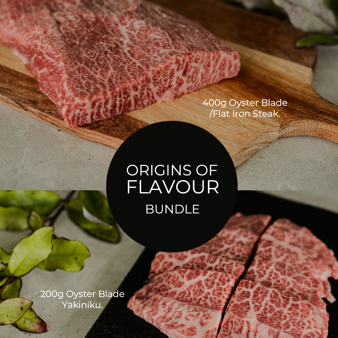 Raw beef on a wooden cutting board with text about 'Origins of Flavour Bundle' and 'Oyster Blade' steaks.